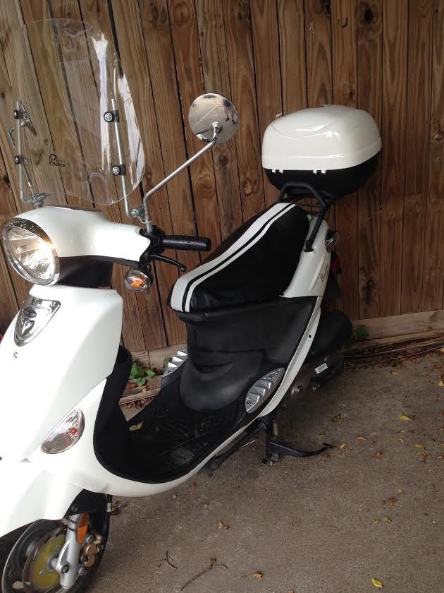 White Genuine Buddy with a black Cheeky Seats low-profile cover and twin white racing stripes