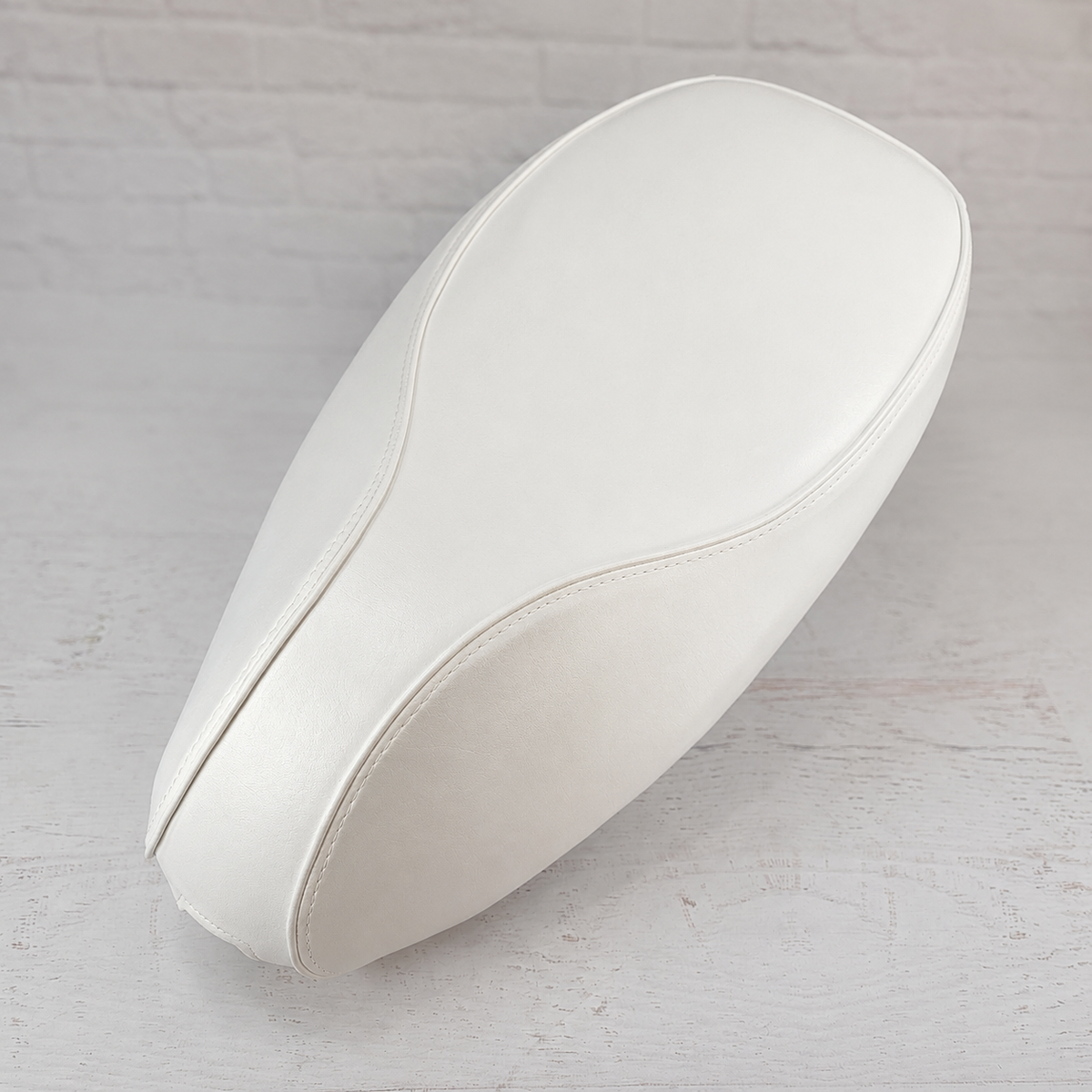 Cottage White seat cover for Vespa Sprint and Primavera, with a clean tailored shape and matching piping, handmade by Cheeky Seats.