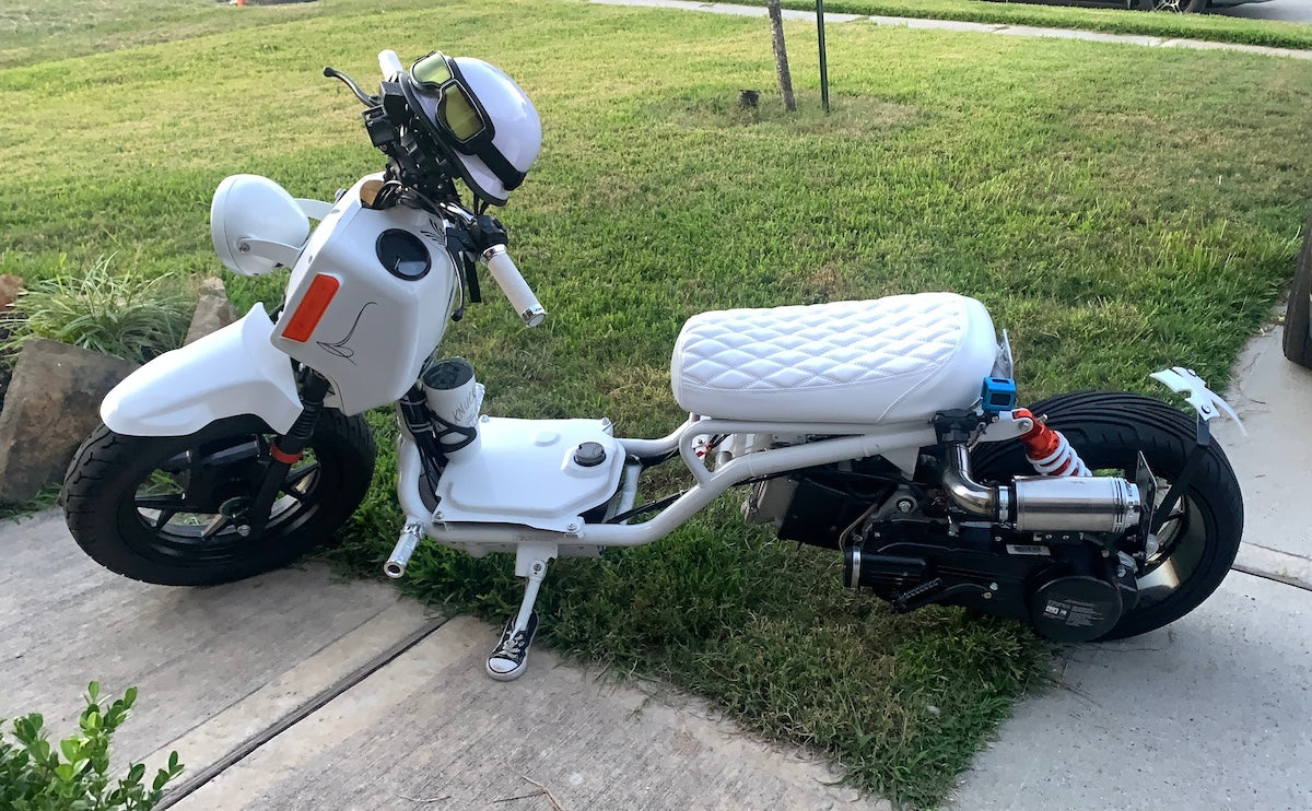 Customer photo of a white Maddog scooter on a sidewalk with the white diamond Cheeky Seats cover installed