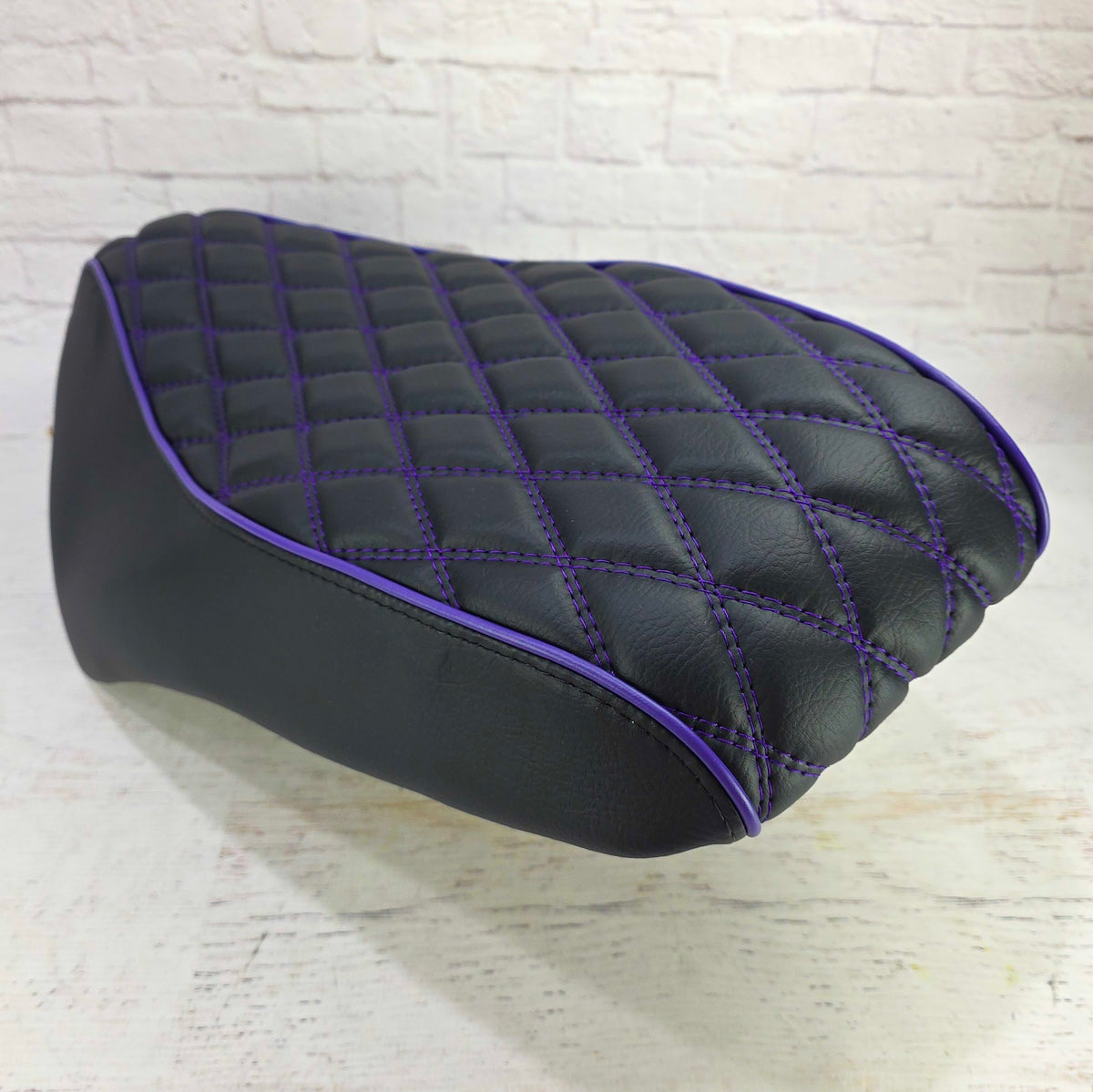 Rear view with rollover of a Genuine Roughhouse 50 seat fitted with a diamond seat cover with purple stitching and piping, handmade by Cheeky Seats
