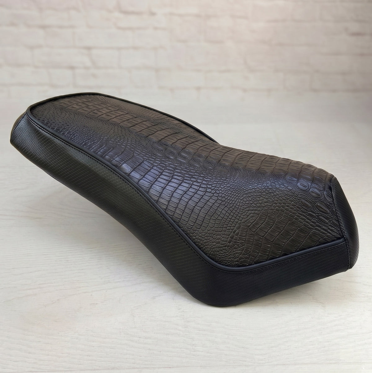 Side view of Genuine Rattler Roughhouse Seat Cover in black gator and black carbon fiber, handmade by Cheeky Seats