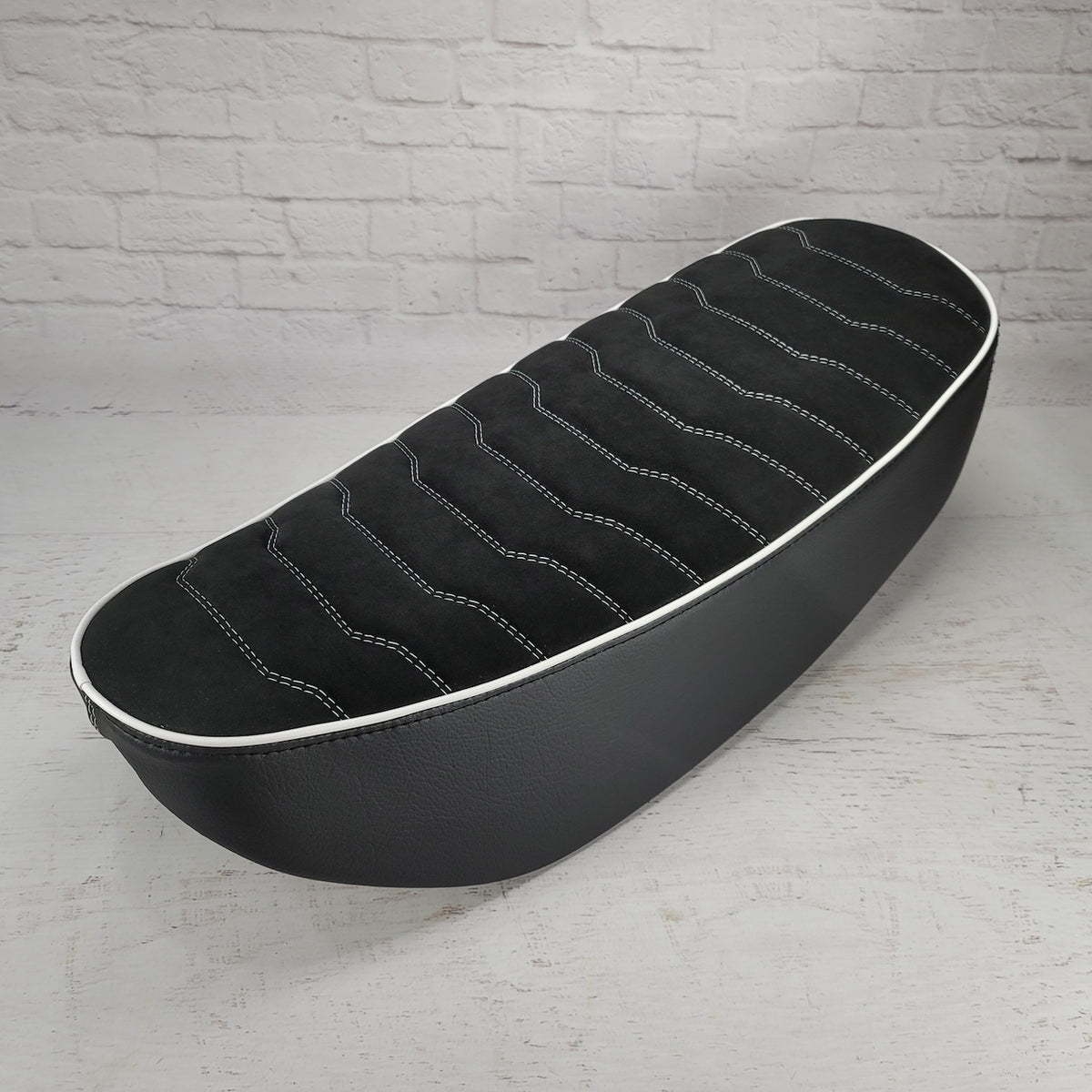 Black Alcantara suede Rayas Honda DAX 125 seat cover with white wave stitching and white piping, handmade by Cheeky Seats