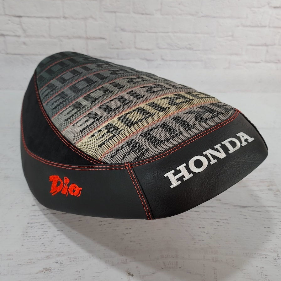 Honda Dio Bride with Alcantara® Suede Seat Cover, with embroidered Dio and Honda logos, red stitching, handmade by Cheeky Seats