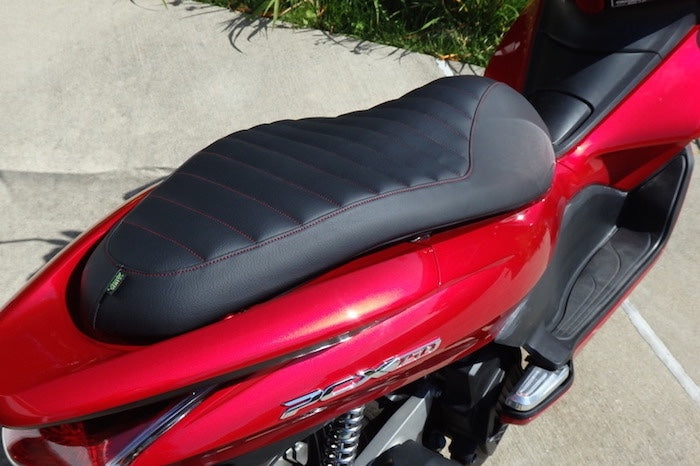 Honda PCX padded seat cover on red scooter