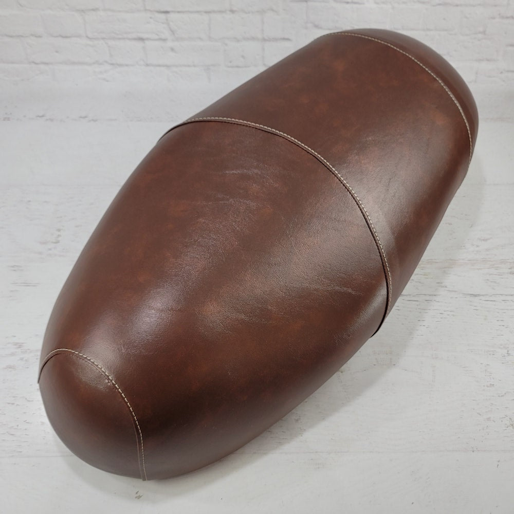 High front view of a distressed whiskey brown Lance Cali Classic and Havana Classic seat cover with contrasting double stitching, handmade by Cheeky Seats