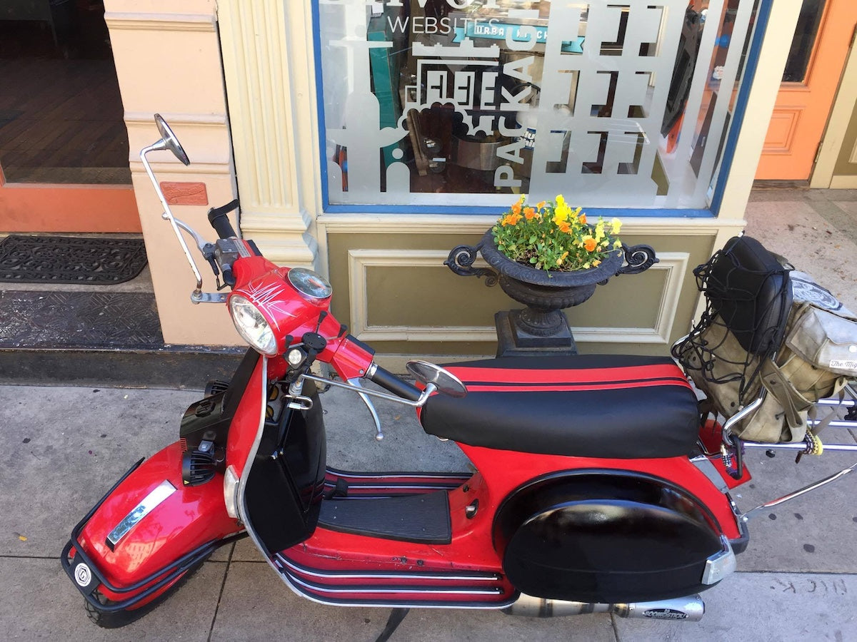 Red Genuine Stella fitted with a matte black Cheeky Seats cover and dual red racing stripes