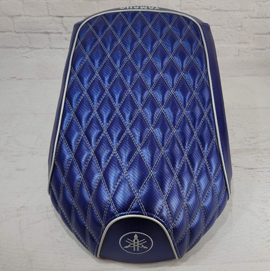 Top view of the Blue Carbon Yamaha C3 seat cover showing the full diamond-quilted panel, silver trim and Yamaha emblem, handmade by Cheeky Seats.