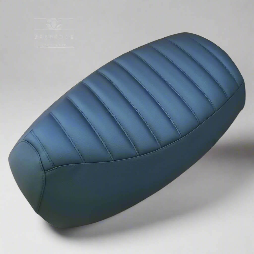 Black tuck-and-roll seat cover for the Yamaha Vino 125, with evenly padded horizontal channels and smooth side panels, handmade by Cheeky Seats.