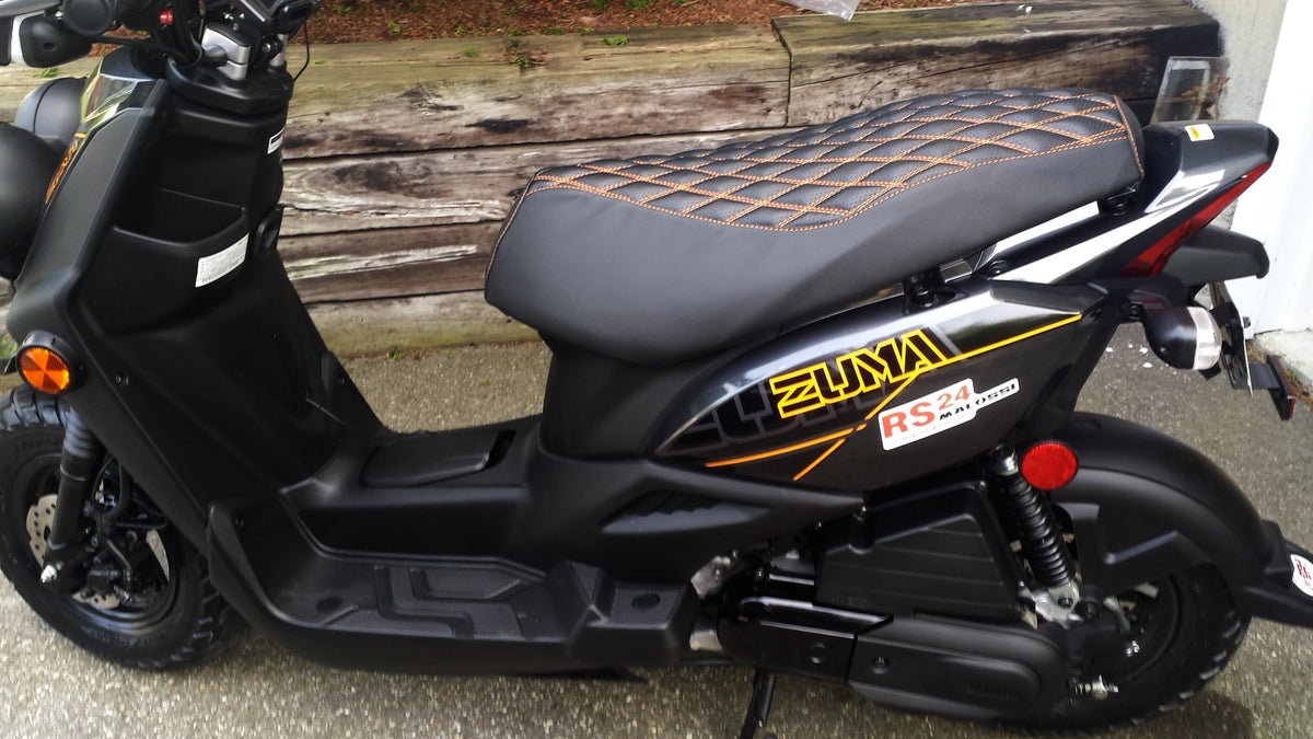 Double Diamond seat cover fitted to a black Yamaha Zuma 50 with warm contrast stitching across the quilted top, handmade by Cheeky Seats.