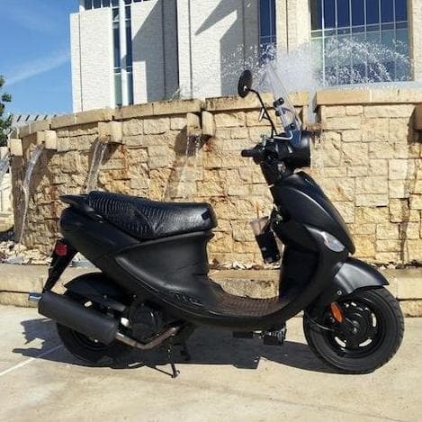 All-black Genuine Buddy with a textured black faux-crocodile Cheeky Seats cover, right-side view