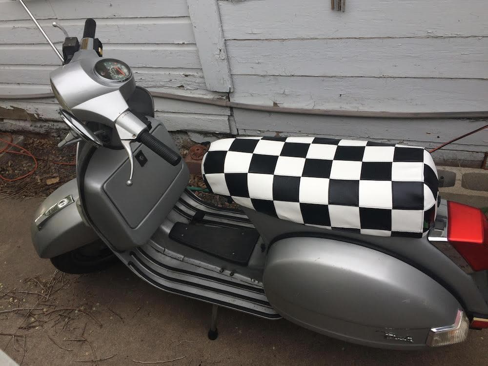 Silver Genuine Stella fitted with a black-and-white checker seat cover handmade by Cheeky Seats