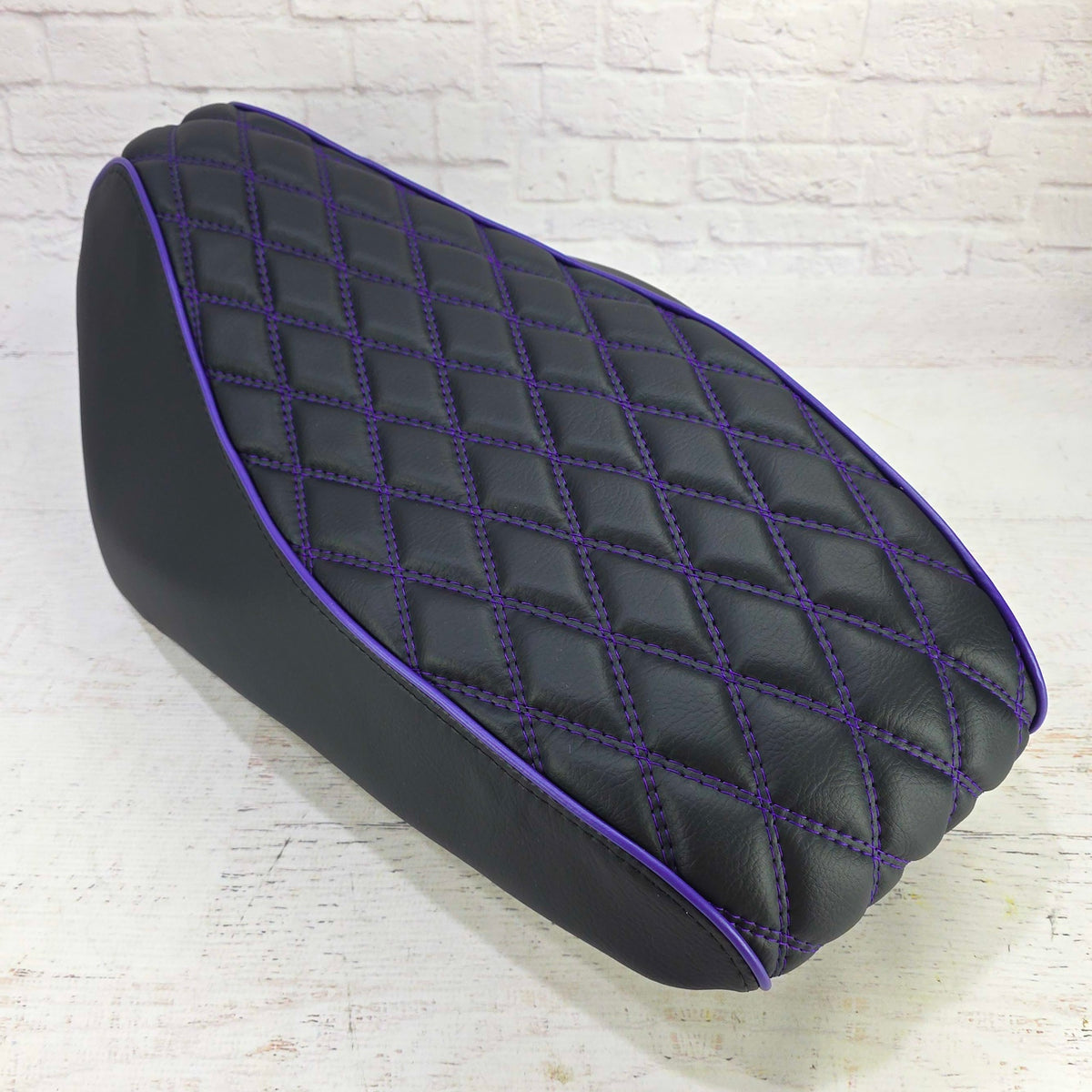Rear top view of a diamond seat cover for the Genuine Roughhouse 50 or Rattler with purple stitching and piping, handmade by Cheeky Seats