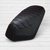 Black padded tuck-and-roll seat cover for Genuine Roughhouse with white stitching, handmade by Cheeky Seats