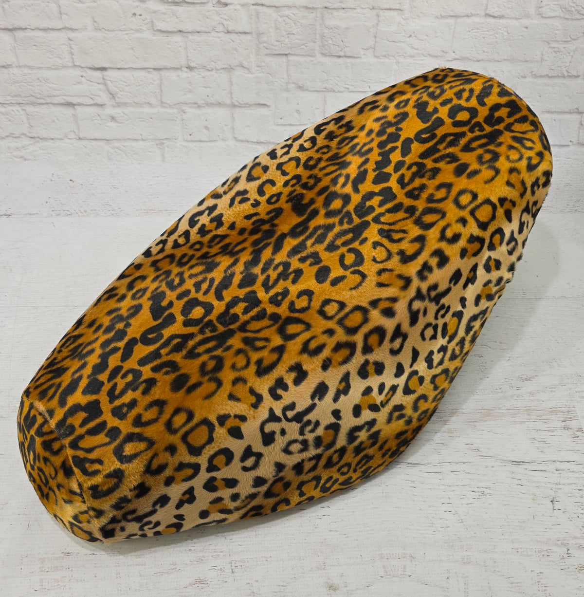 Golden jaguar-print faux-fur Cheeky Seats cover for a Genuine Buddy seat, front-left studio view
