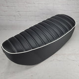 Black tuck-and-roll Honda DAX 125 seat cover with white double stitching and white piping, handmade by Cheeky Seats