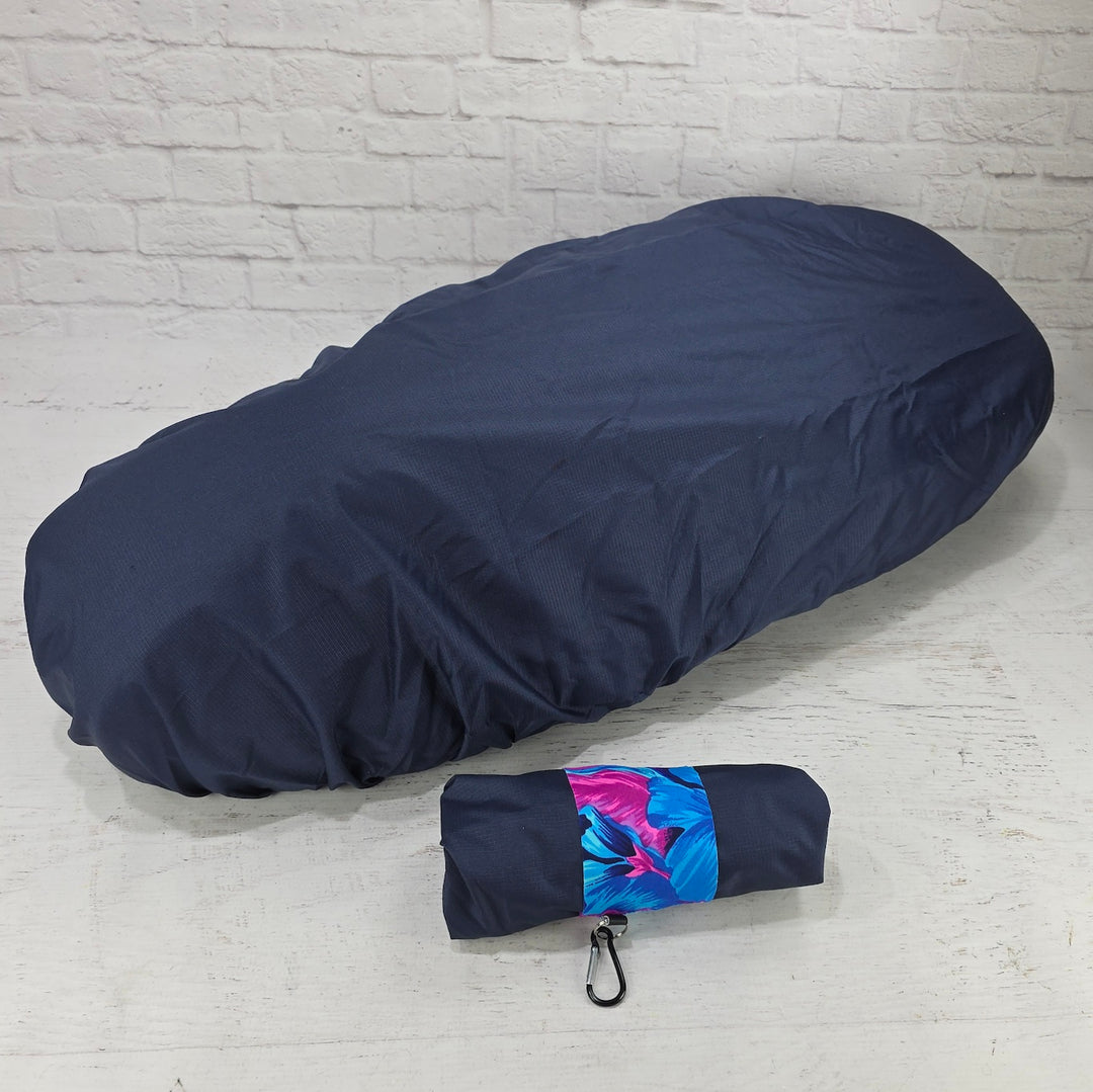 Navy Honda DAX 125 protective seat cover with a compact pouch, blue floral strap and small clip, by Cheeky Seats