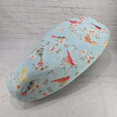 Stylized songbirds on branches on a robins egg blue background