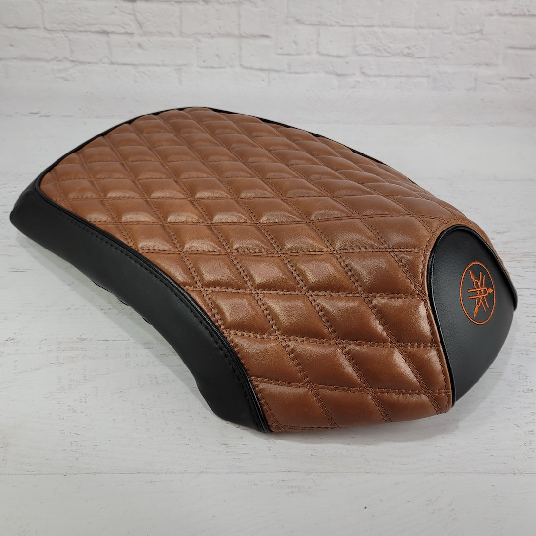 Side profile of the Black and Tan diamond seat cover tailored for Yamaha C3, XF50, Vox and Giggle scooters, handmade by Cheeky Seats.