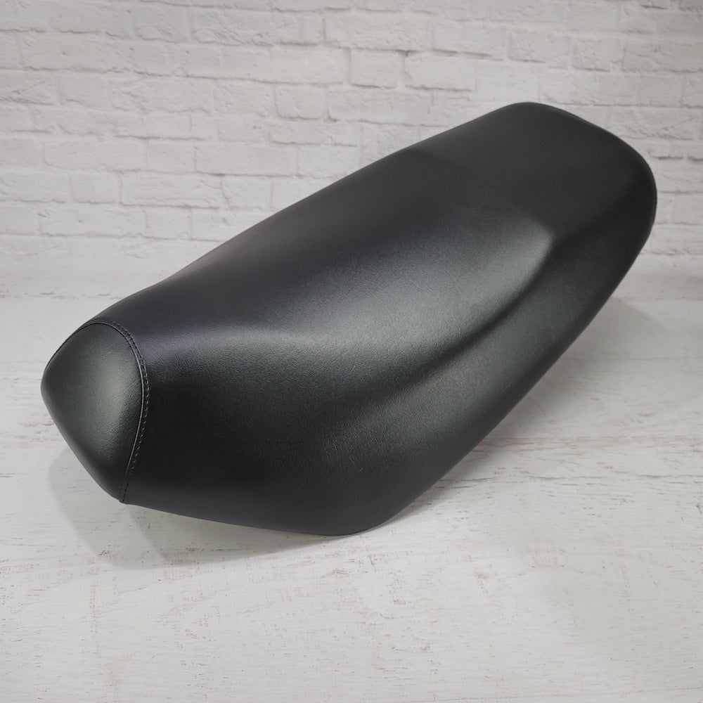 Side view of the Classic Black Yamaha Zuma 50 seat cover showing its clean profile and fitted front seam, handmade by Cheeky Seats.