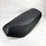Black Croc and Gator Yamaha Zuma 50 seat cover with an embossed reptile-texture center and smooth side panels, handmade by Cheeky Seats.