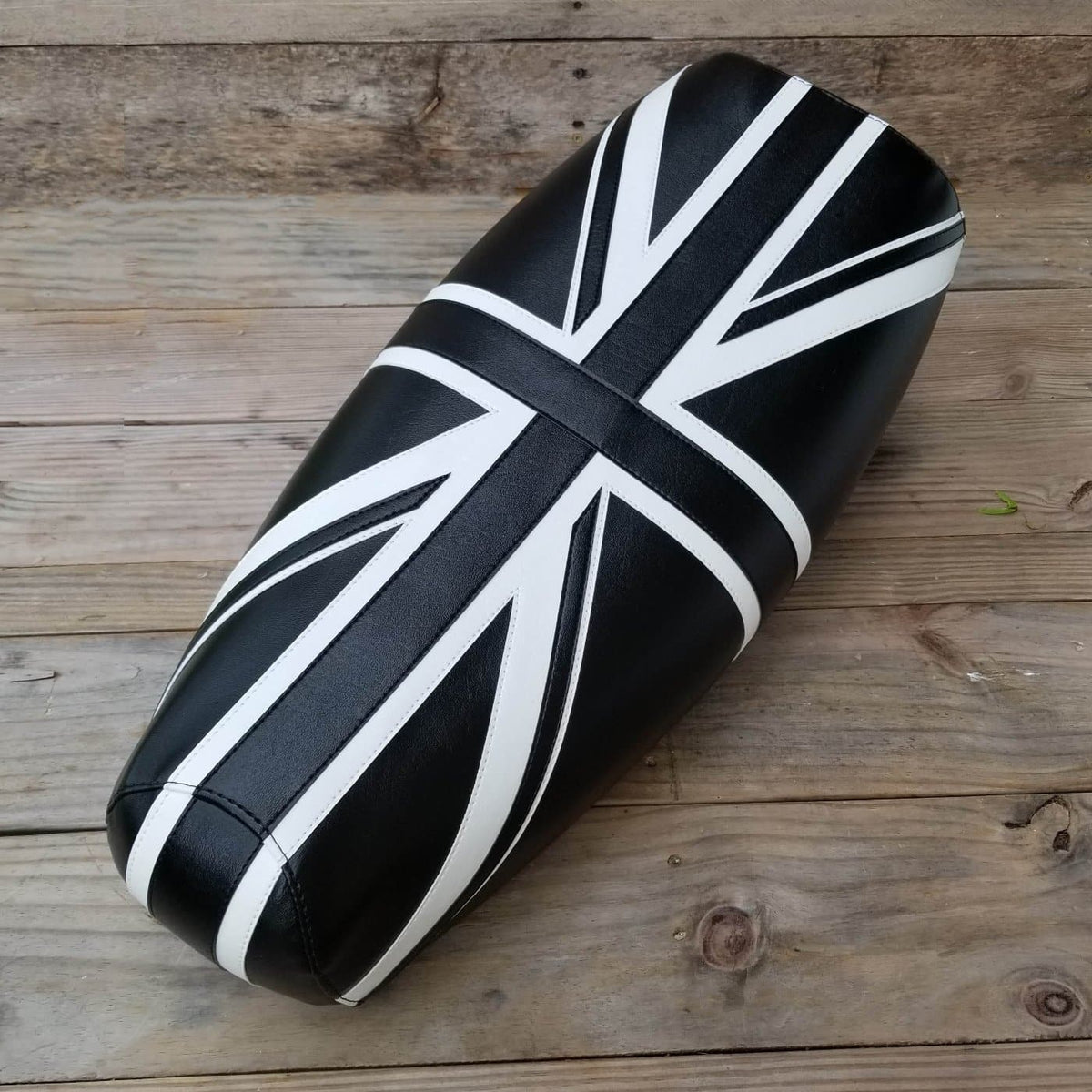 Black Genuine Stella seat cover with a hand-cut and sewn white Union Jack, handmade by Cheeky Seats